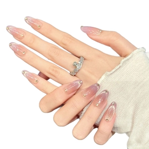 Pink and purple gradient press-on nails with fine glitter and gold stud accents