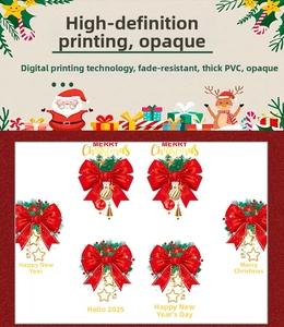 Macro detail of Christmas window decals with red bows, pine needles and gold bells