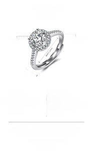 Macro detail of silver heart ring with round cut gemstone and micro-paved crystals