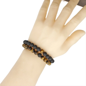 Tiger eye and black lava stone bead bracelet set for men and women on a wrist