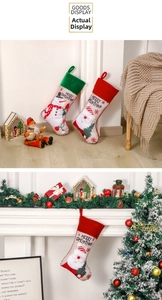 Detail of Christmas stockings with Santa and Snowman hanging by a cozy fireplace