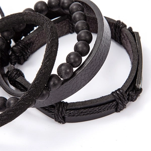Detailed view of black multi-layer bracelets featuring stone beads and braided leather cords