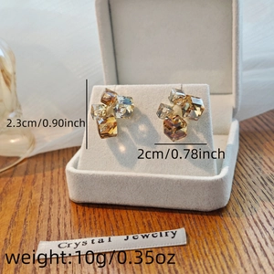 Macro shot of cube crystal earrings in jewelry box with precise size dimensions