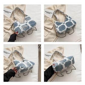 Detail view of denim handbag with white plush plaid pattern and acrylic chain strap