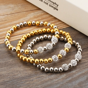Chic 4-piece set of gold and silver beaded elastic bracelets with crystal disco ball charms