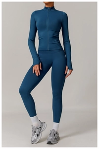 Detail of navy seamless yoga set featuring thumb holes on sleeves and high waist fit