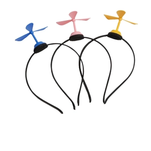 Close-up of colorful cartoon dragonfly propeller headbands in blue pink and yellow colors