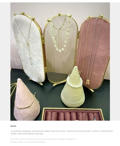 Detailed view of luxury velvet jewelry display stands with gold metal mesh screen