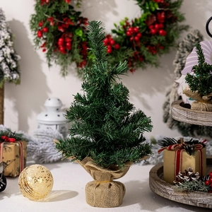 Close-up of a 30cm mini Christmas tree with a burlap base and festive ornaments