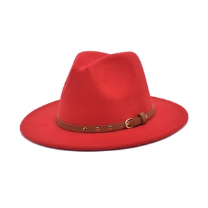 Detail of red wool felt fedora with brown leather band featuring gold stud accents