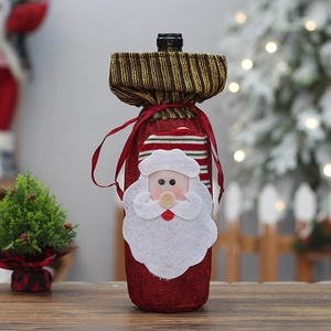 Detailed close-up of Santa Claus wine bottle cover with red burlap and felt textures