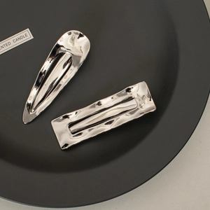 Minimalist silver metal hair clips with hammered texture in teardrop and rectangle shapes