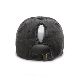 Detail of washed black ponytail baseball cap showing the back opening and metal buckle