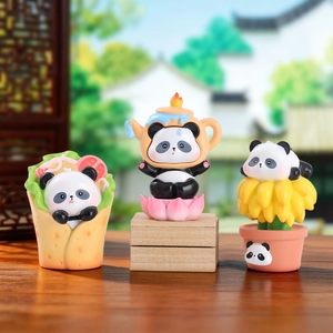 Three creative panda resin figurines in burrito teapot and flower pot on wooden desk