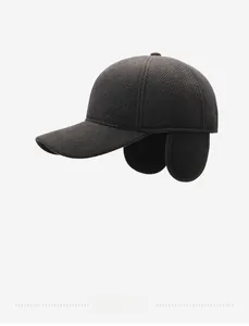 Detailed view of dark brown winter baseball cap with ear protection and Jeans embroidery