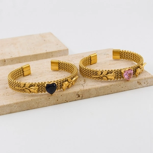 Luxurious gold rose heart bangles with blue and pink stones on stone base