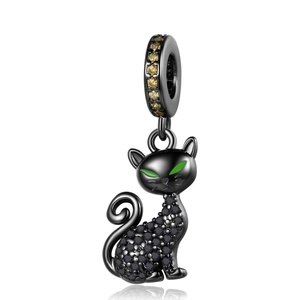 Detailed view of a black metal cat pendant with green eyes and sparkling black crystals