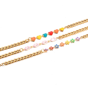 Gold stainless steel bracelet set featuring colorful enamel heart, lip, and flower charms