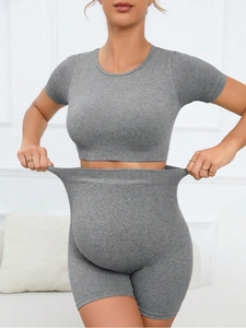 Macro shot of high-stretch seamless ribbed grey knit fabric on maternity activewear shorts