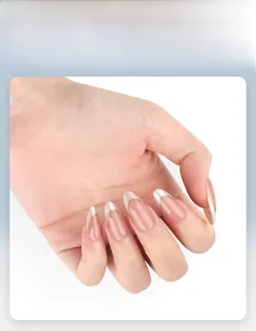 Detailed view of almond-shaped press-on nails with white French tips and gold line detail