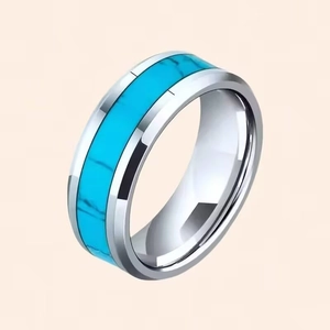 Detailed view of a men's titanium steel ring with turquoise inlay and polished finish