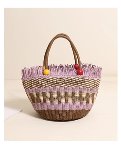 Detail of straw bucket bag featuring purple tassels and colorful wooden beads on the handle
