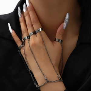 Punk gunmetal slave bracelet featuring multiple connected rings on female hand
