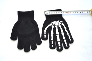 Glow-in-the-dark fingerless skeleton gloves showing width measurement with a ruler