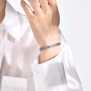 Close-up of silver mesh woven bracelet in stainless steel on a model wrist