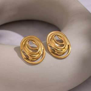 Minimalist gold spiral earrings with geometric curved lines on soft grey background