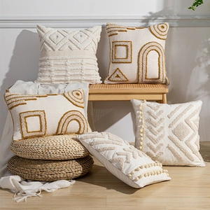 Collection of bohemian tufted geometric cushion covers in cream and mustard yellow tones