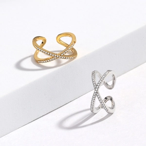 Detail of gold and silver crisscross rings with sparkling micro-pave zirconia stones