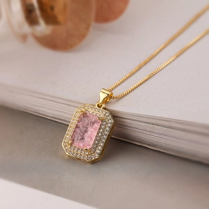 Elegant 18K gold plated necklace with a rectangular pink zircon pendant on a white book