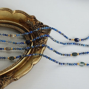 Handmade multilayered natural stone beaded necklace with blue crystal and gold accents