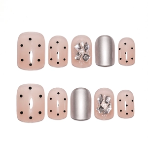 Short nude press-on nails set with silver mirror finish, black polka dots and rhinestones