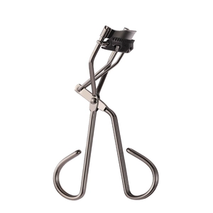 Professional deep grey stainless steel eyelash curler with black rubber pads on white background