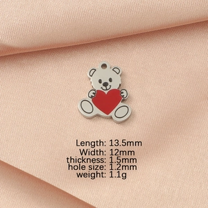 Detail view of silver bear pendant with red heart, including precise dimensions and weight