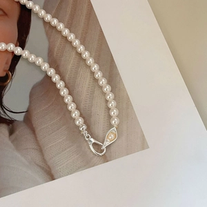 Detail of 925 sterling silver buckle and white pearls on a vintage French style necklace
