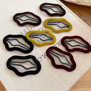 Set of eight velvet flocking irregular wave hair clips in black, brown, yellow, and red