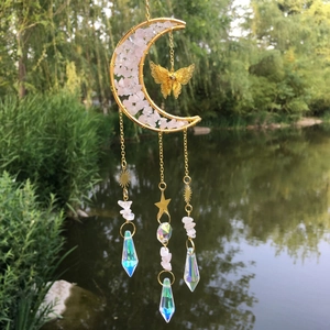 Moon dreamcatcher with pink crystals, golden butterfly and prisms in garden setting