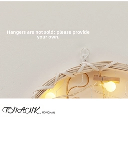 Detail of DIY Christmas wall hanging with warm LED globe lights and wooden photo clips