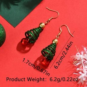Sparkly multi-layer Christmas tree earrings with red bell and gold hooks on festive red background
