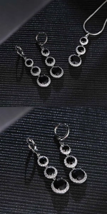 Detail of silver waterdrop jewelry set featuring black gems and sparkling zircon stones