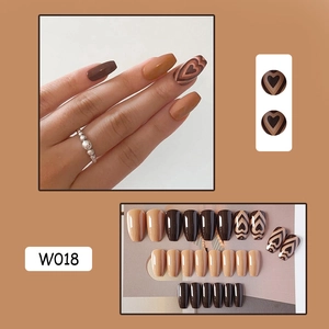 Detail of coffee brown press-on nails W018 with latte art hearts and coffin shape