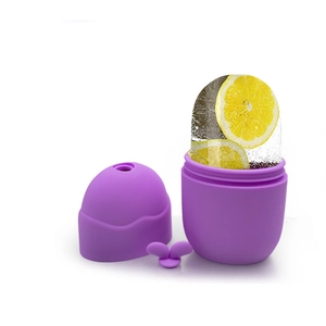 Purple silicone facial ice roller mold with lemon slices for skin massage and cooling