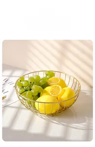 Macro detail of Nordic gold iron fruit basket with lemons and grapes in sunlight