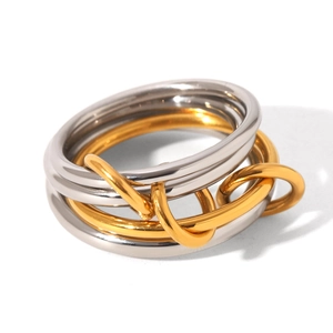Macro view of polished two-tone stainless steel rings with gold and silver finish