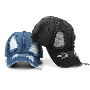 Distressed denim baseball caps with ripped holes and metal cross pendants in blue and black