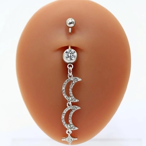 Silver belly button ring with moon and star heart pendant shown on a model