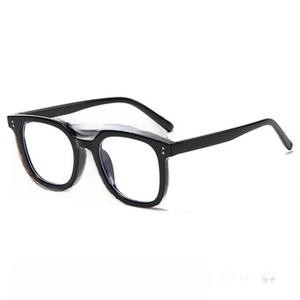 Close-up of classic black eyewear with dual rivet hinges and stylish rectangular frames